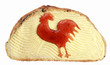 Festive sandwich with butter and cockerel from jam. Funny creative concept for the Christmas holiday and the new year with a rooster out of a jam on the sandwich on a white background.