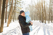 © satura_ - Happy father playing with little child son boy in winter nature