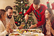 © Kalim - Group of friends celebrating Christmas