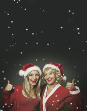 Two Santagirls Laughing And Showing Thumbs Up