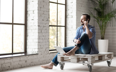 Wall Mural - Positive good looking man speaking on the phone