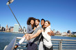 © goodluz - Group of friends taking selfie picture, Manhattan in background