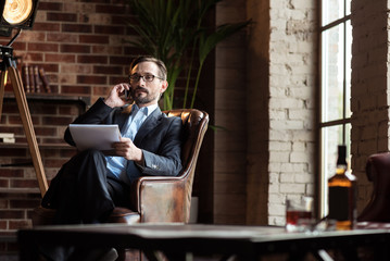 Wall Mural - Self employed stylish man speaking on the phone