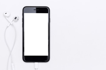 Poster - phone blank screen and headphone on white table top view