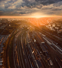Aerial View Of Railroad Station At Sunset. Trains And Carriages In A Sump.