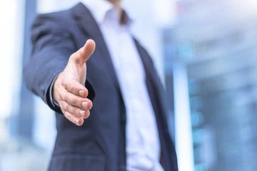 Businessman with an open hand ready for handshake