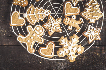 Wall Mural - Christmas gingerbread cookies with icing on dark background