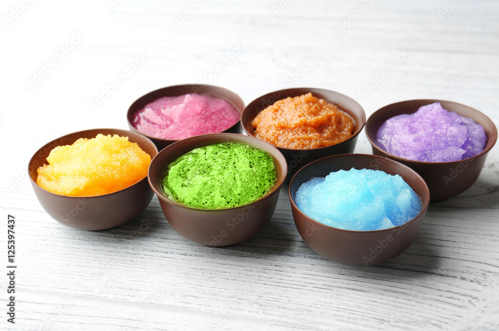 Body scrubs on wooden background