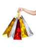 © julenochek - Womans hand holding colorful shopping bags