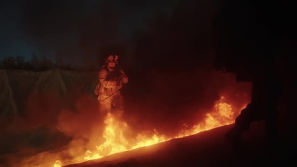 Wall Mural - Group of Armed Soldiers Running through Fire During Night Military Operation. Slow Motion.