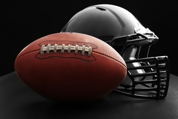 Canvas Print - Rugby ball and helmet on dark background