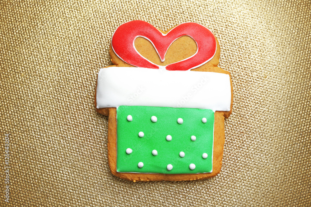 Tasty gingerbread cookie on textured background, close up view