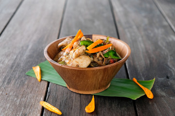 Stir fried chicken with spicy curry paste on wood plate/ Thai fo