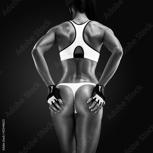 Fototapeta na wymiar Back of a fit and muscular woman athlete in sports bra