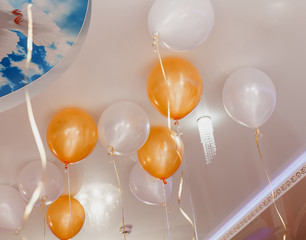 Colorful balloons floating on the ceiling of a party