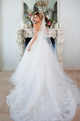 Charming young bride in luxurious wedding dress. Pretty girl, photo Studio