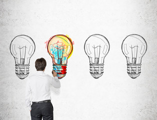 Wall Mural - Businessman coloring a light bulb sketch