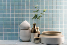 Ceramic Vase And Bowl Decoration In A Bathroom With Blue Mosaic Tile