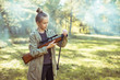 © Room 76 Photography - Girl shooting from the air rifle in the forest