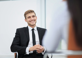 Poster - Image of young businessman communicating with his colleague