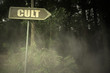 old signboard with text cult near the sinister forest