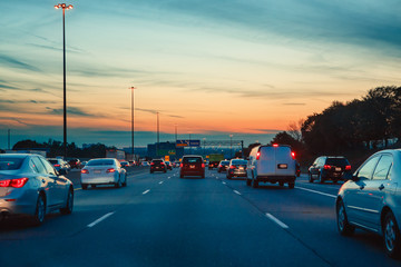 Night traffic, cars on highway road on sunset evening night in busy city, urban view, toned with Instagram filters