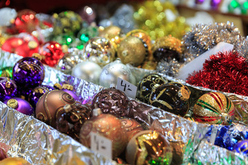 Colorful close up details of christmas fair market. Balls decora