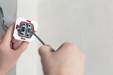 Electrician Hands With Screwdriver Installing Wall Socket