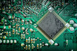 Close up of a printed green computer circuit board. electronics and IT manufacturing and business background