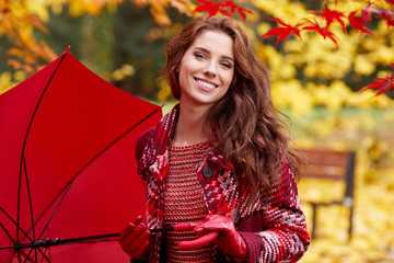 Wall Mural - Beautiful woman in autumn park 