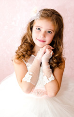 adorable smiling little girl in white princess dress