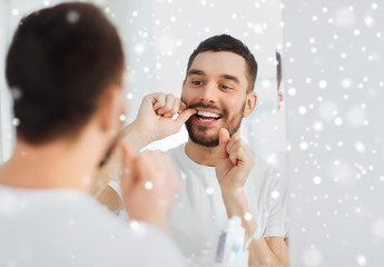 Poster - man with dental floss cleaning teeth at bathroom