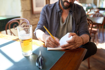 Sticker - close up of man with beer and notebook at pub