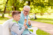 © Syda Productions - old man and boy eating ice cream at summer park