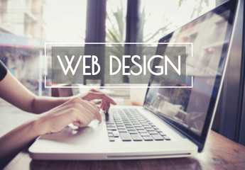 business hand typing on a laptop keyboard with web design homepage on the computer screen website ho
