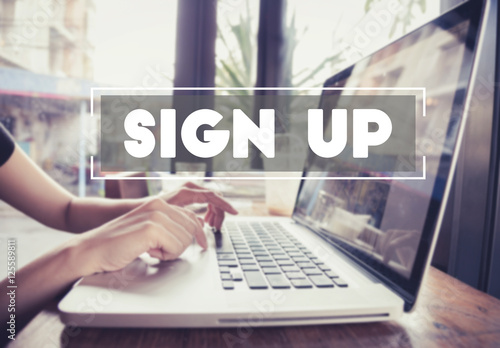 Fotomural business hand typing on a laptop keyboard with Sign Up homepage on the computer screen register join applicant enroll enter membership concept