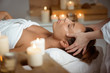 Leinwandbild Motiv Young beautiful girl having face massage relaxing in spa salon.