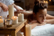 © Cookie Studio - Young beautiful girl relaxing in spa salon. Focus on candles.