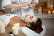 © Cookie Studio - Young beautiful girl in mask for face relaxing in spa salon.