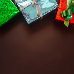 Christmas background with decorations and gift boxes on wooden b