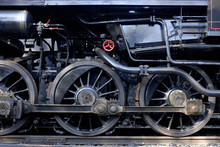 Steam Locomotive Wheels And Rods Closeup. Detail Of Mechanical Parts, Wheels And Equipment Of The Train.