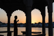 Silhouette of a sadhu performing ritual prayer in the evening at Pushkar Lake. One of the holiest place in India