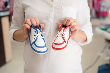 Unrecognizable Pregnant Woman Shopping Shoes For Her Baby