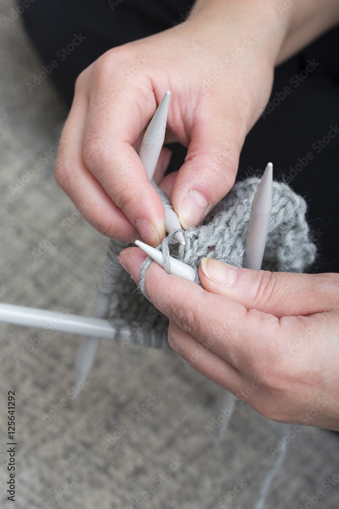 Woman is knitting.
