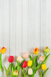 © ulkas - Tulips flowers on light wooden background.