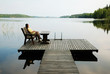 © OlegMit - Lake with wooden platform and woman resting.