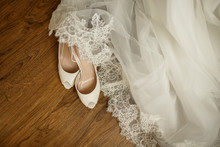 Wedding Accessories. Bridal Shoes, White Dress And Veil On The Wooden Floor At Wedding Morning Preparation, Best For Wedding Banners, Backgrounds, Backdrops And Wedding Invitations