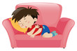 Little boy napping on pink sofa
