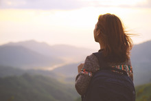 Hipster Young Woman With Backpack Enjoying Sunrise View On Mountain