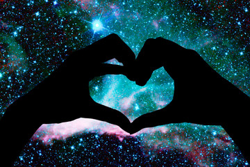 hands in the shape of a heart, starry night background